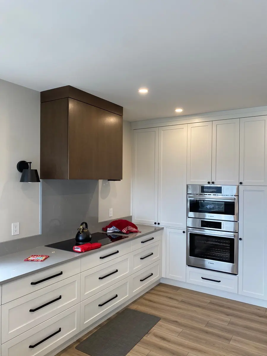 Finished kitchen after renovation with recessed lights, pendant lighting and electrical fixtures in place.